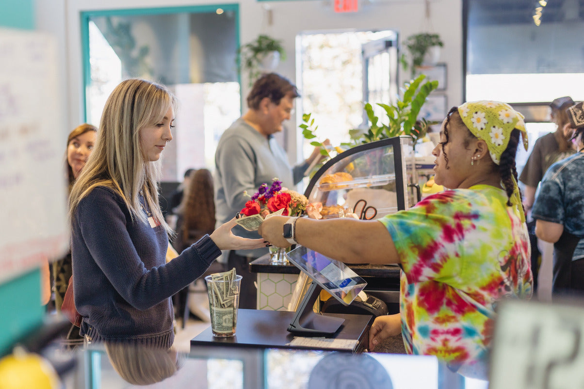 A customer and barista at a coffee shop